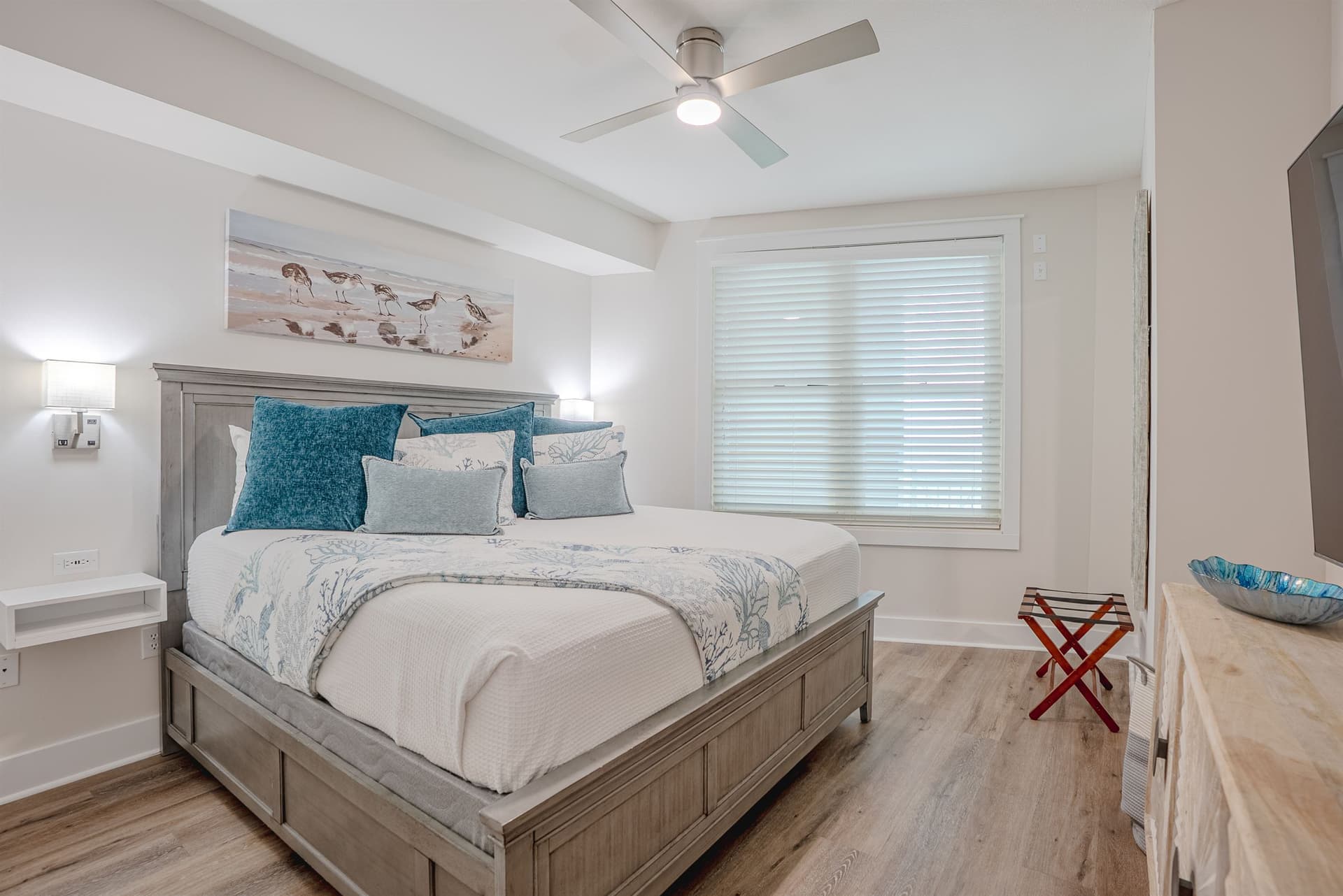 Primary bedroom with king bed and teal accent pillows