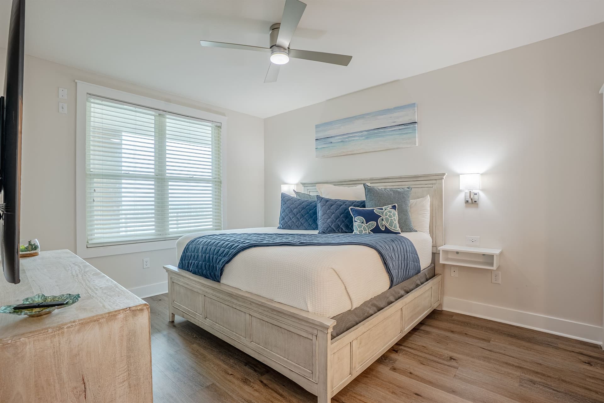 Guest bedroom with queen bed and navy coastal bedding