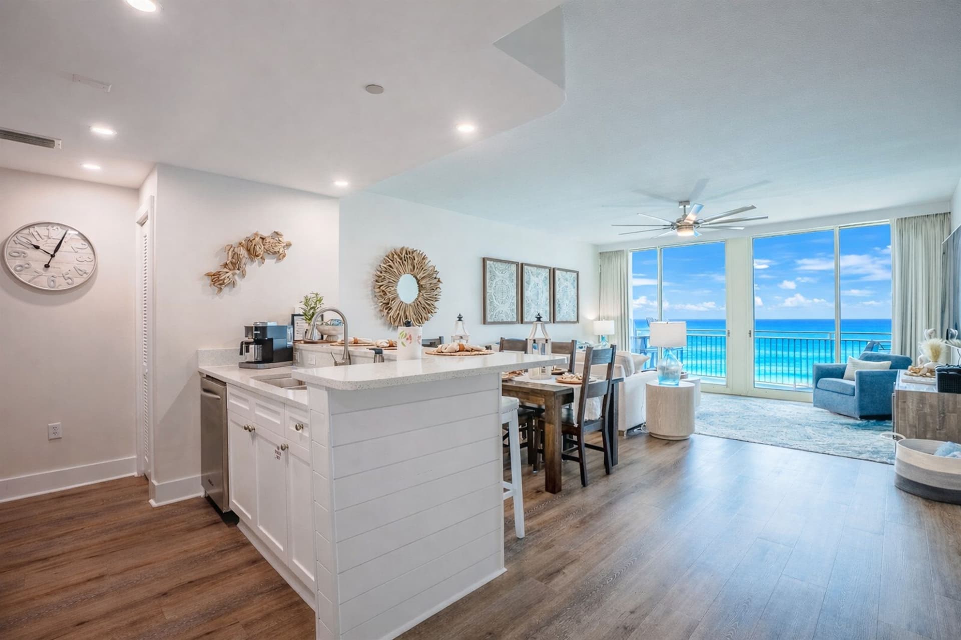 Kitchen island with bar seating opening to dining and living area