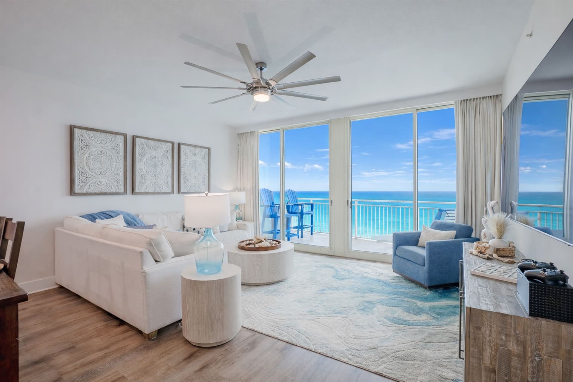 Living room wide angle with coastal decor and balcony access