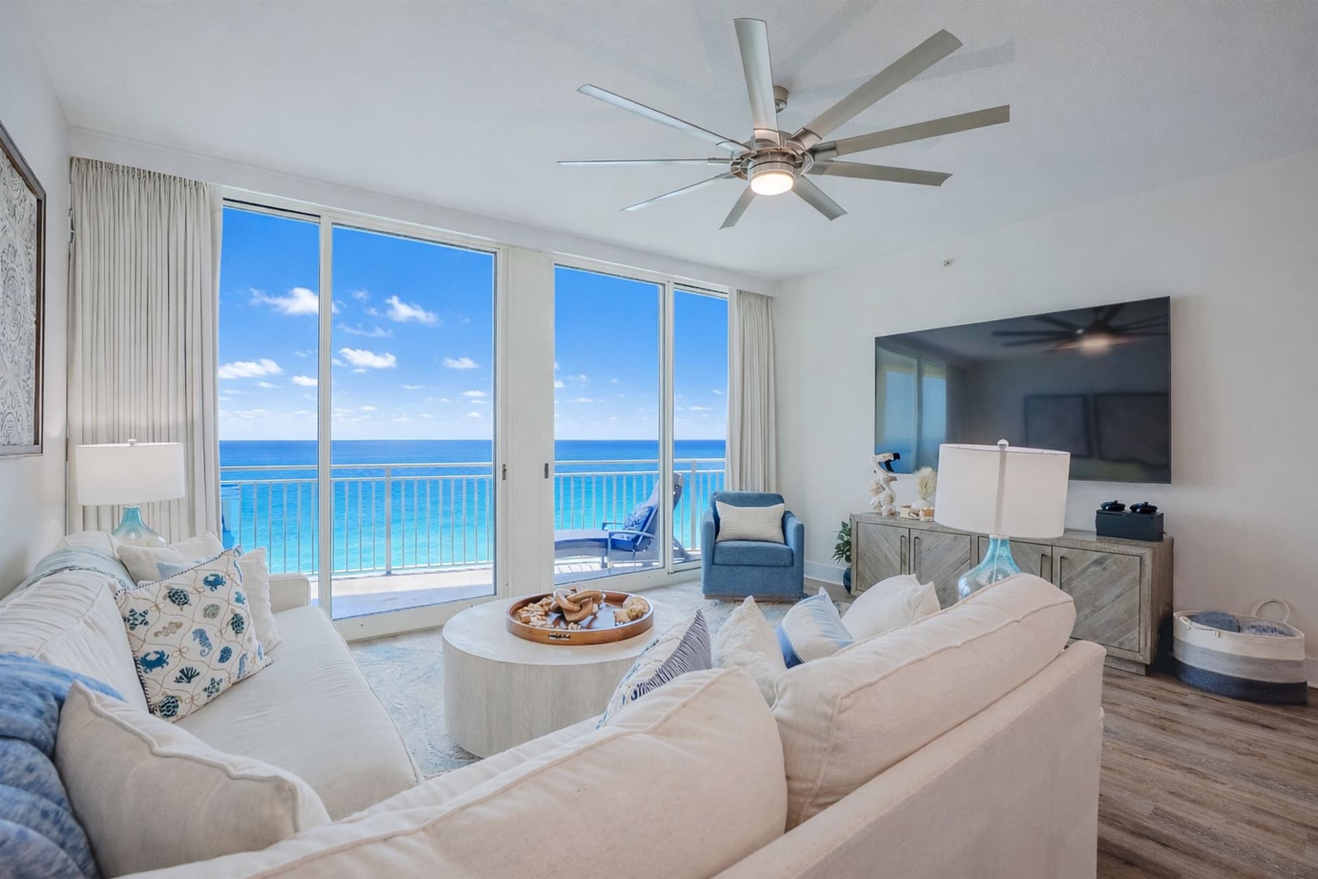 Living room with sectional sofa and floor-to-ceiling gulf views