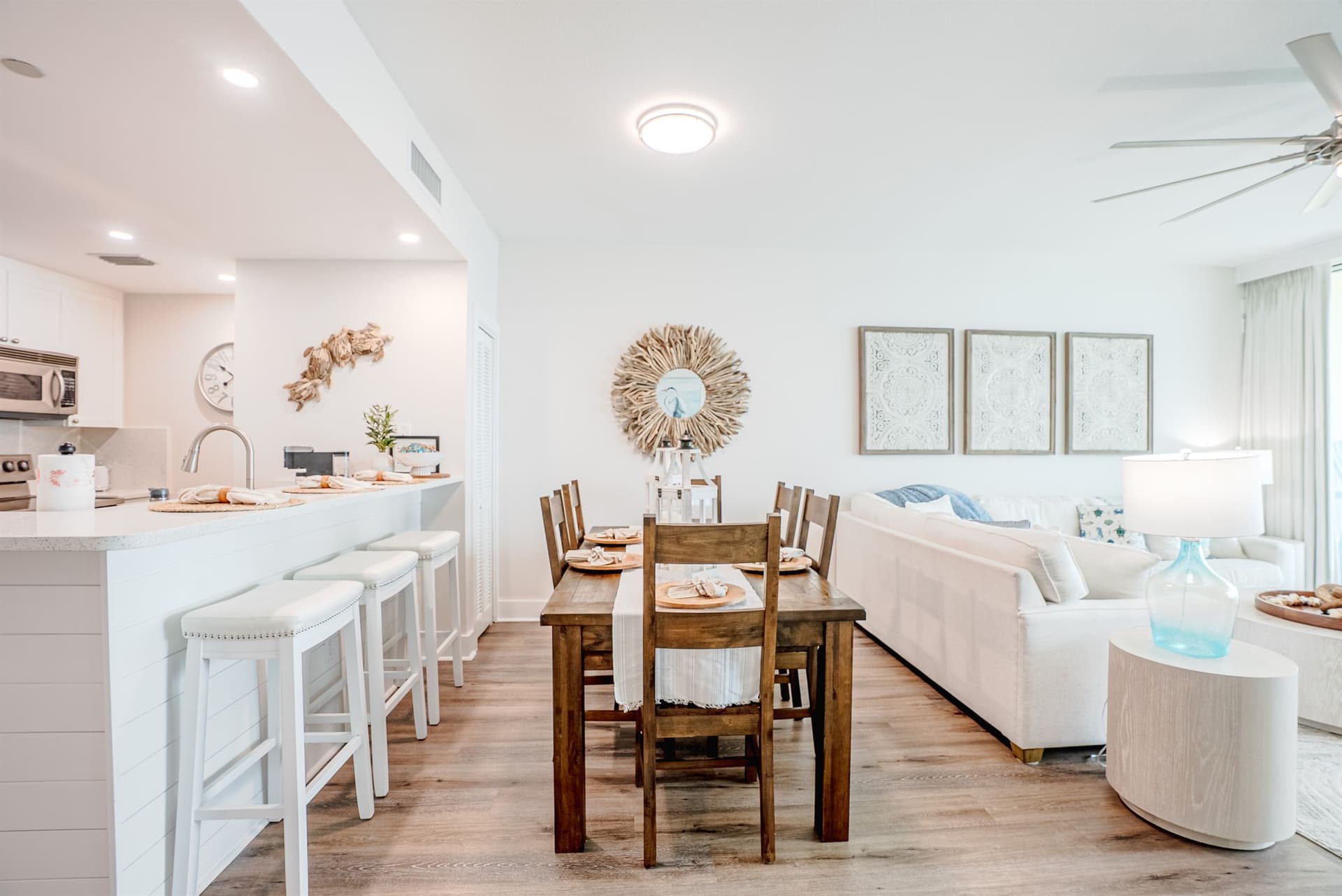 Dining table set for six with kitchen bar seating alongside